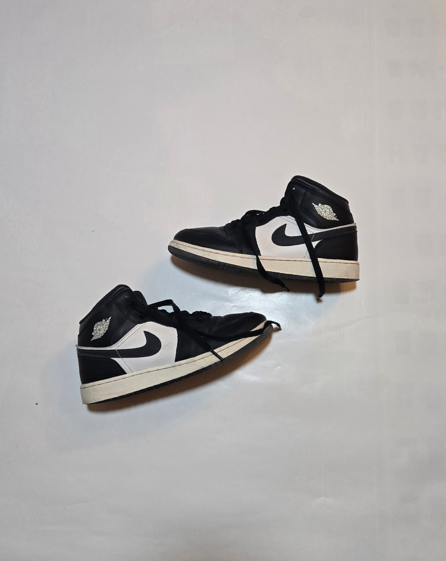 Black and white Air Jordan 1 Mid sneakers featured by REGISTR